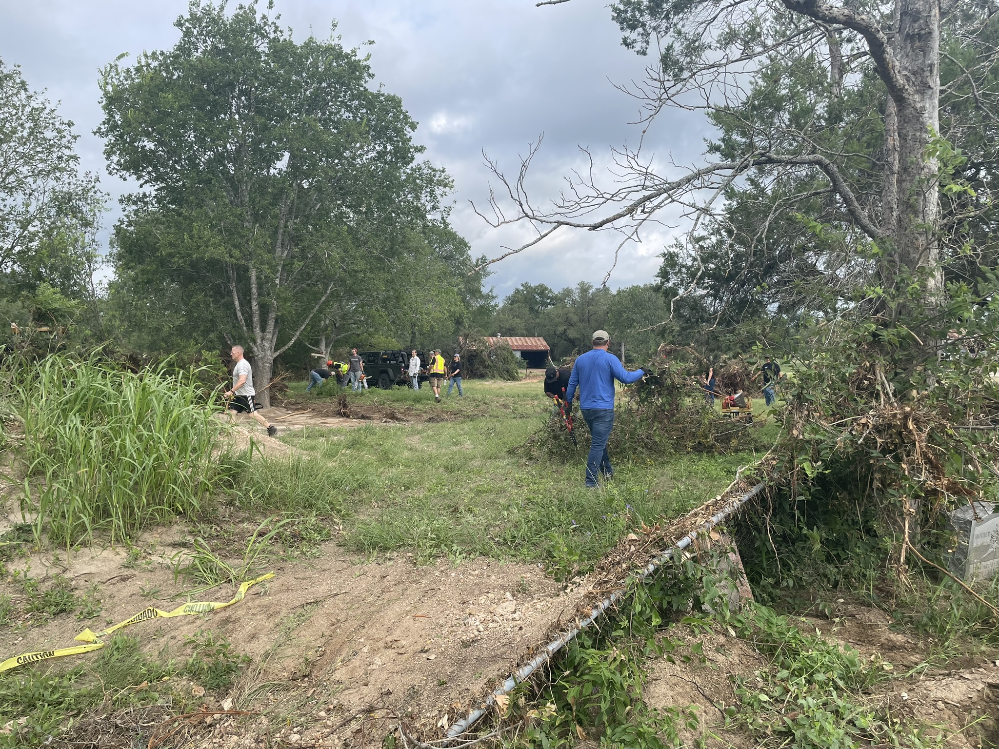 Cleanup volunteers hauling brush and tree limbs