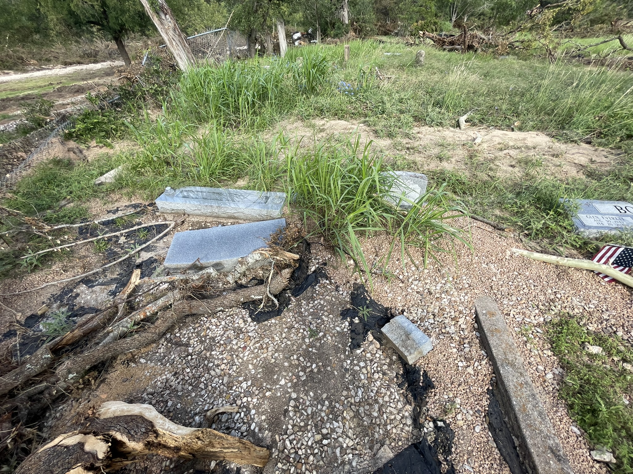 Headstones knocked over and displaced by floodwaters