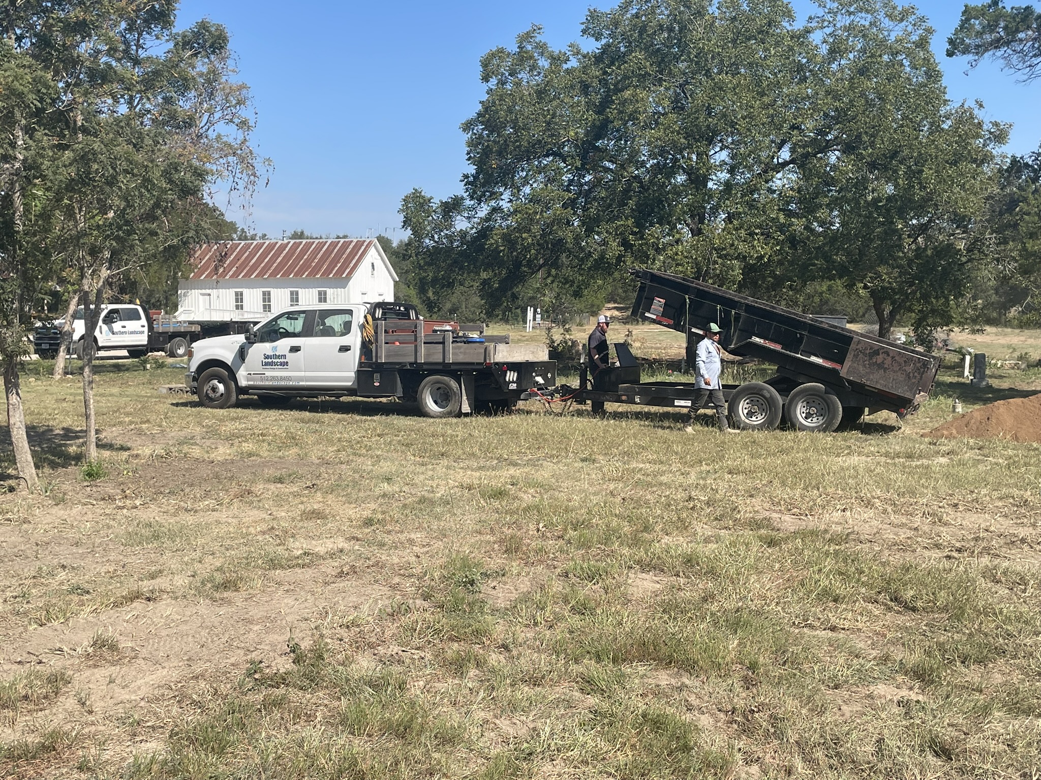 Southern Landscapes truck and dump trailer hauling fill dirt